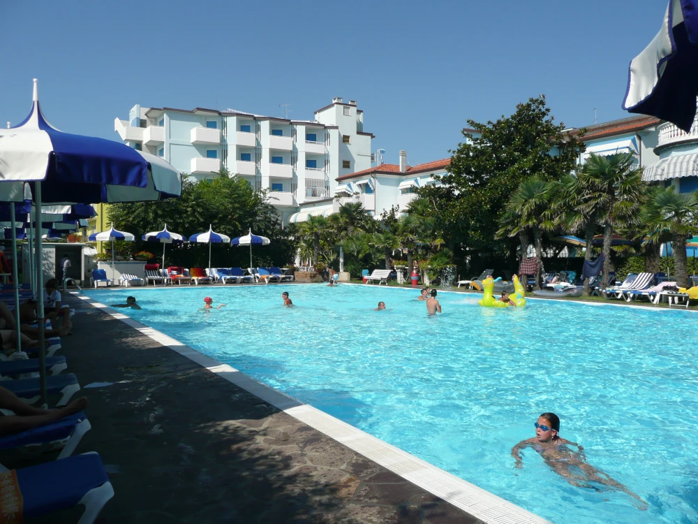 Hotel swimming pool surrounded by sun loungers